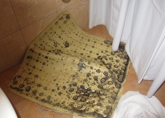 Dirty mouldy rubber bath mat