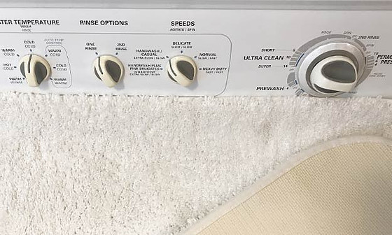 How do you clean fabric bath mats with rubber backing ?
