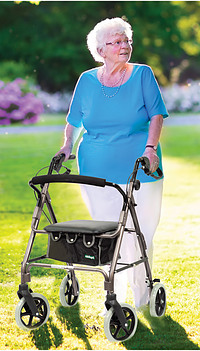older woman using a 4 wheel rollator walker